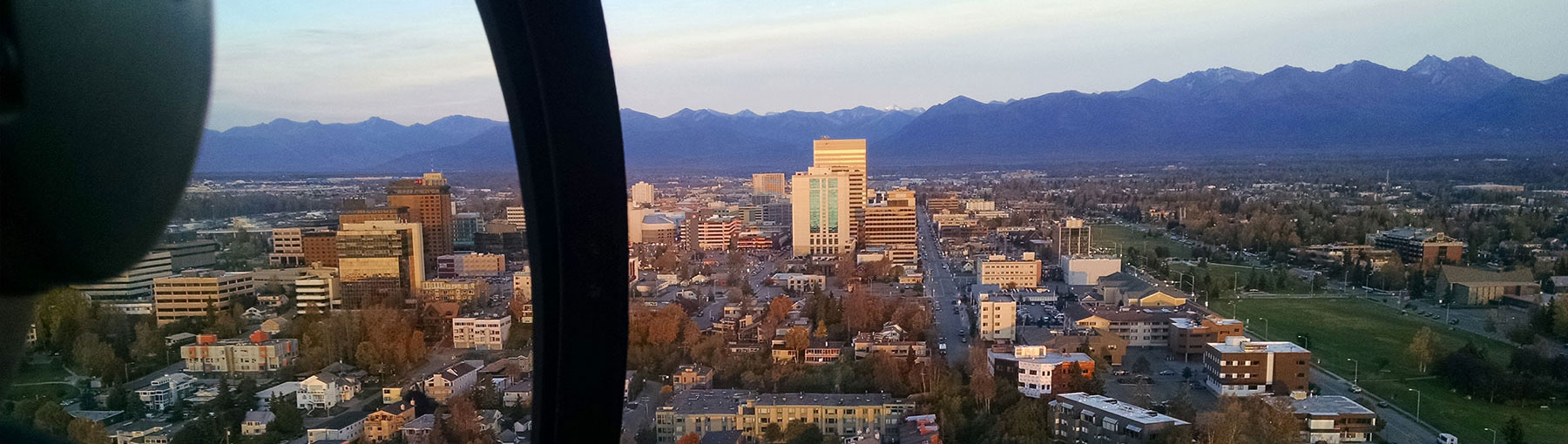 View of downtown Anchorage Alaska from helicopter cockpit.