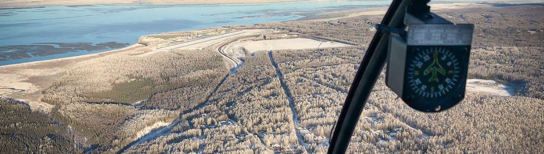 View of frosty ground out of helicopter cockpit.